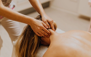 Registered massage therapist working on womans neck