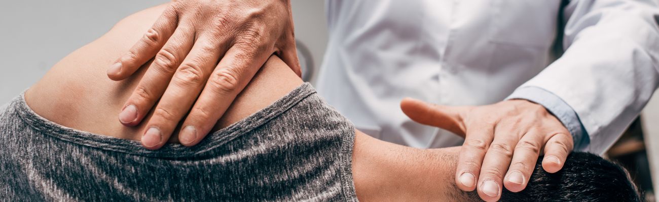 Chiropractor touching mans back