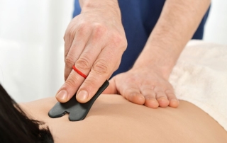 Gua sha therapy on woman's back