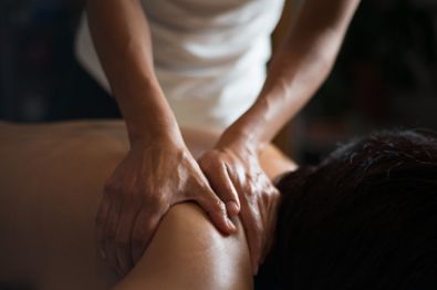 A woman receiving a shoulder massage