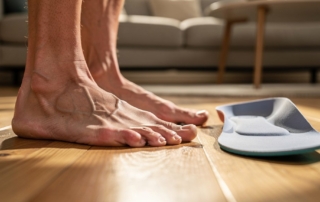 Bare feet on wood floor with insole clayton heights chiropractic